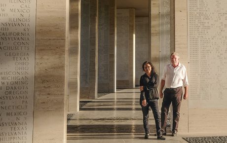 Mark Gillen ’77 and his wife, Delmafe Festin, standing at the Manila American Cemetery between stone columns
